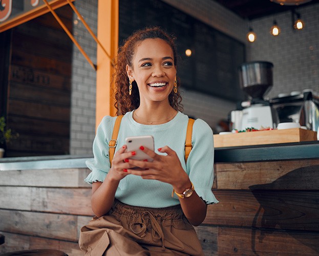 smiling woman sitting on barstool at restaurant