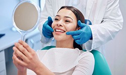 Woman smiling at reflection in mirror