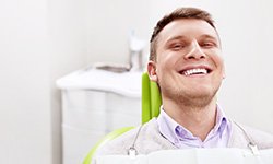 Smiling man sitting in dental office