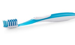 Close-up of a toothbrush with a blue handle