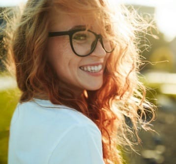 Woman with beautiful smile after orthodontics