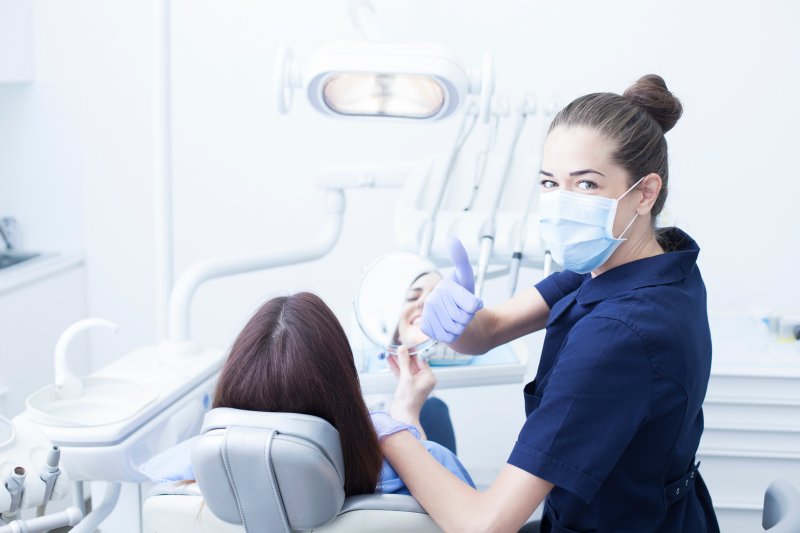 Dentist giving a thumbs-up after cosmetic dentistry treatment